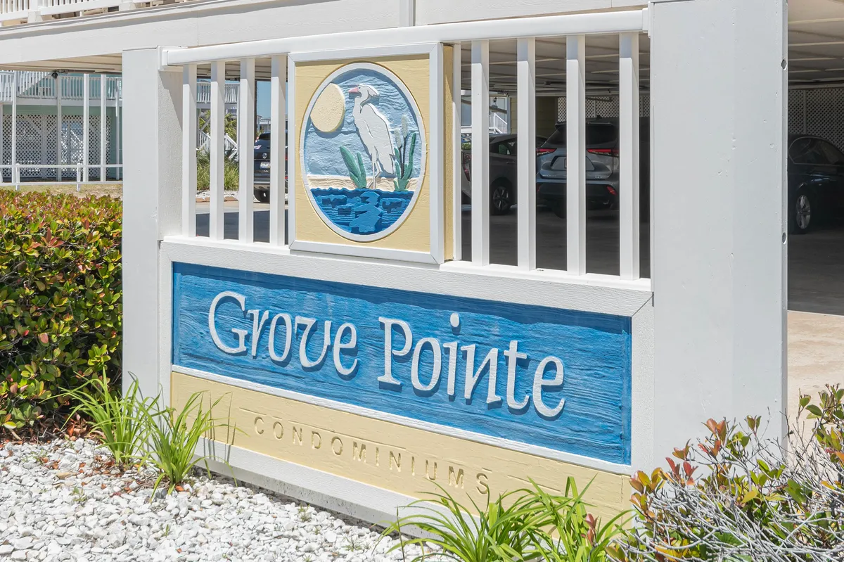 This exterior image features the Grove Pointe sign set amid lush greenery, with an illustration of a heron, evoking a sense of arrival to a vibrant community near natural attractions. The surroundings suggest easy access to local adventures and family-friendly outdoor activities.